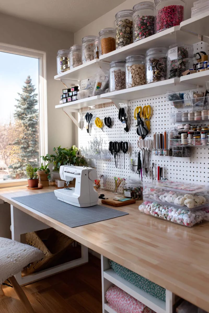 15 sewing room organization ideas to remove and inspire creativity 5 Pegboard tool wall with labeled hooks for scissors, rulers and rotary cutters 1